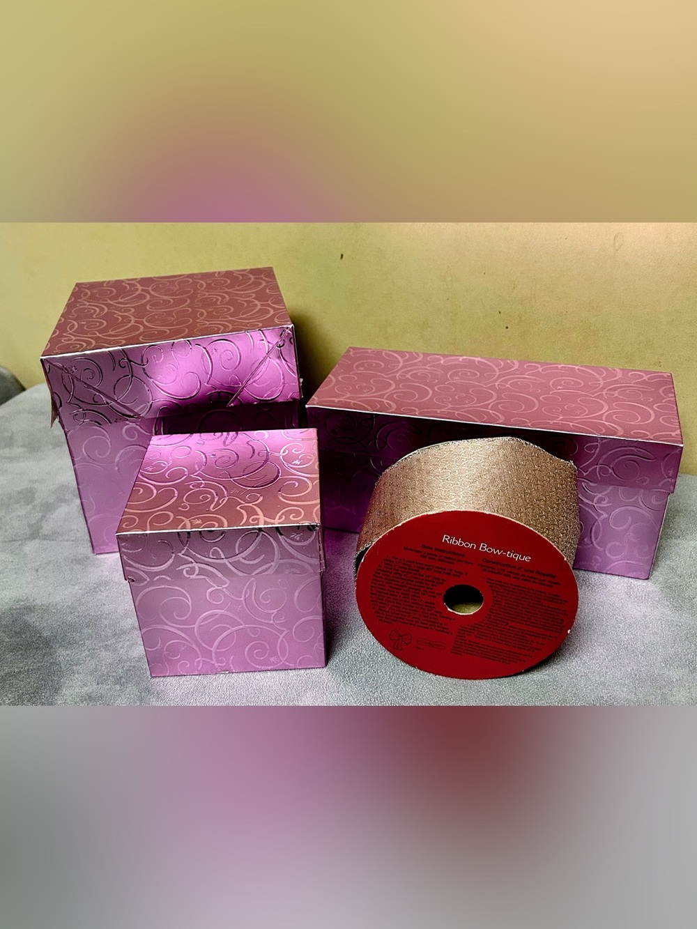 Decorative set three pink/mauve gift boxes and one roll of pink/silver ribbon